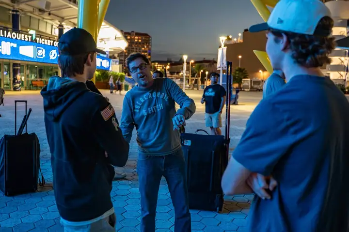 Players catching up outside the arena at dusk