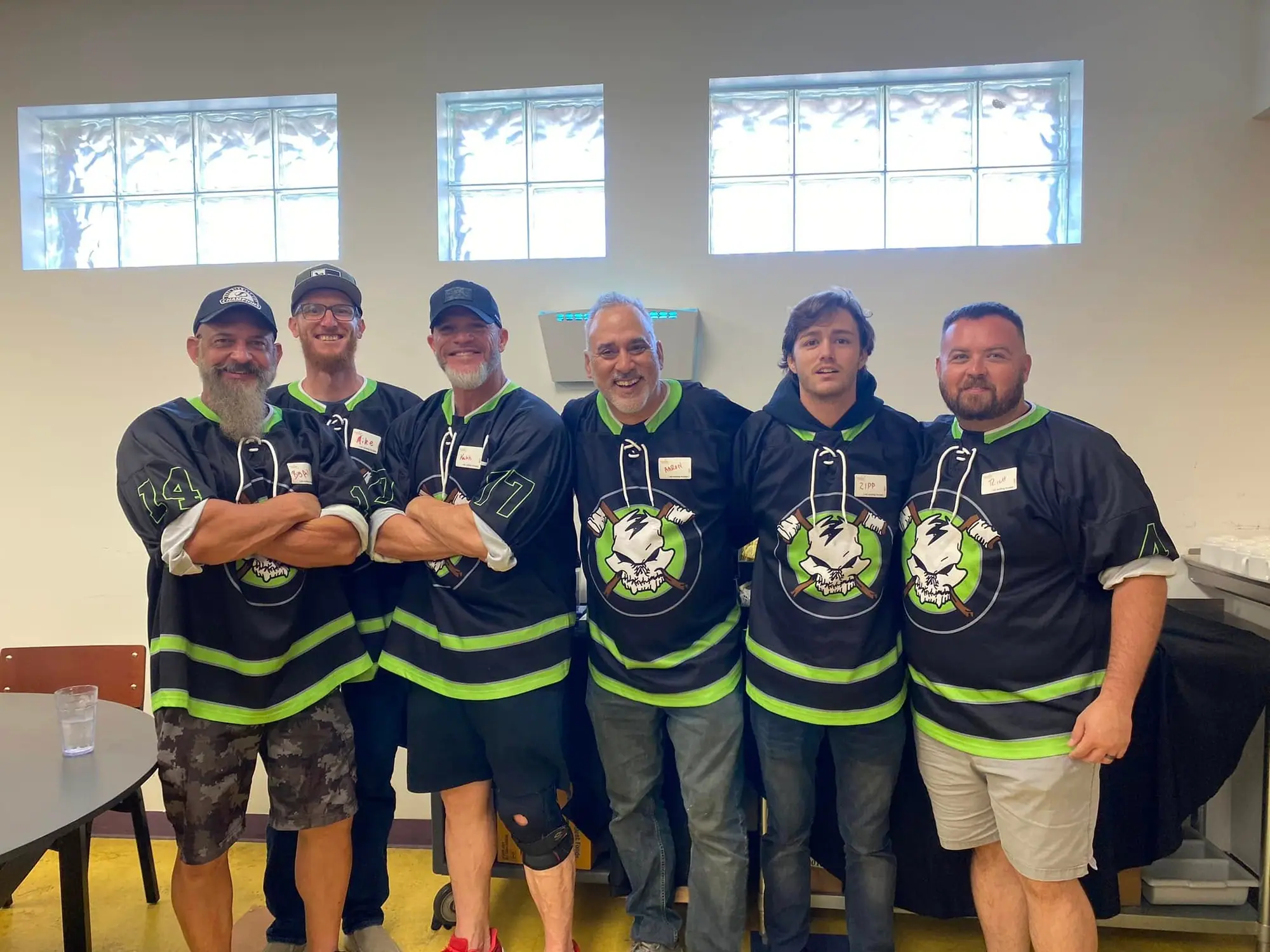 Stick N Bones volunteers in team shirts at Trinity Cafe